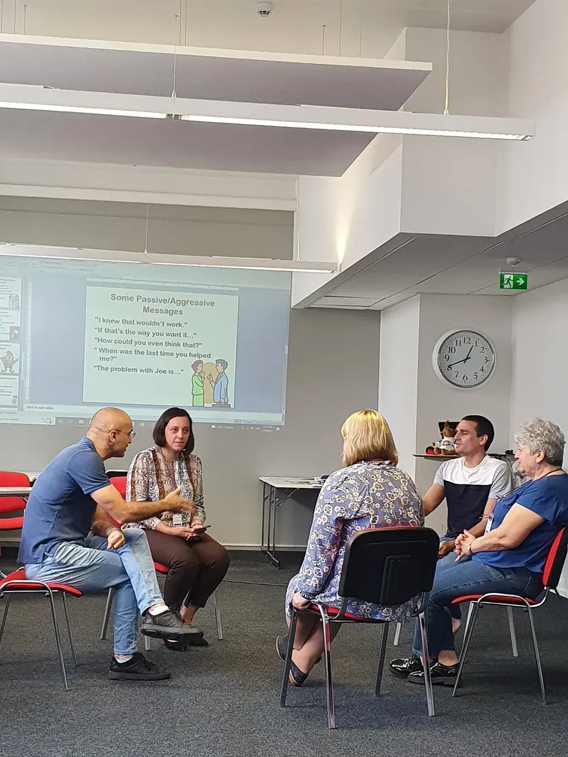 Participants in a circle discussion during a session on communication