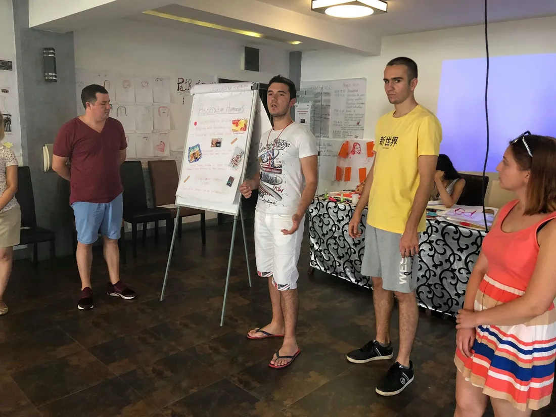 Participants presenting at a flipchart during a workshop session